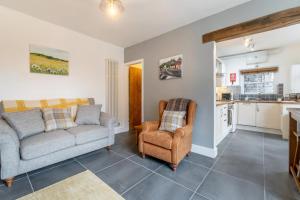 a living room with a couch and chairs and a kitchen at 1 Bed in Ambleside oc-lr036 in Ambleside