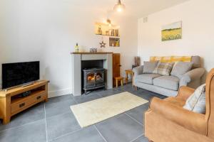 a living room with a couch and a fireplace at 1 Bed in Ambleside oc-lr036 in Ambleside