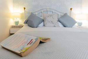 a bedroom with a bed with a book on it at 1 Bed in Ambleside oc-lr036 in Ambleside