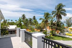a view from the balcony of a house with palm trees at Villa By the Beach - sleeps 6 plus in Nassau
