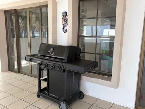 a grill sitting on a table next to a building at Front Beach Beautiful house with pool & AC in Pochomil