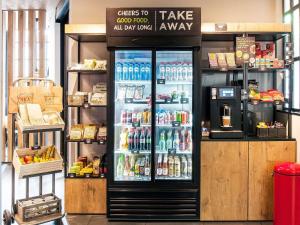a drink cooler in a store with drinks in it at ibis Epinay sur Seine - Gennevilliers in Épinay-sur-Seine