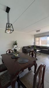 a living room with a table and a couch at Waterfall Apartments Waterfall Cres in Midrand