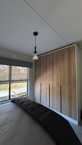 a room with a large bed with a large window at Waterfall Apartments Waterfall Cres in Midrand +47 photos