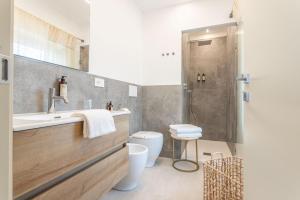 a bathroom with a sink and a toilet and a shower at valter rooms 2 in Castel del Piano