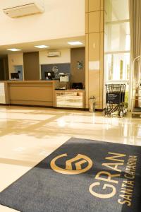 a hotel lobby with a welcome mat on the floor at Hotel Gran Santa Catarina in Indaial