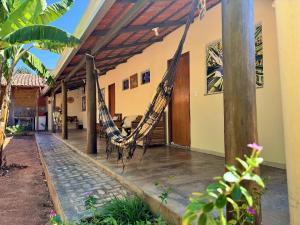a hammock hanging from the side of a house at Pousada Canela de Ema in Mateiros