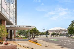 a building with a sign in front of a street at VCAY Hotel 5BR 5BA Group Suite Near Superdome in New Orleans