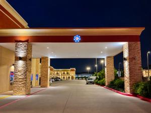 a gas station at night with a car dealership at Crystal Inn Downtown in Houston