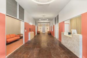 a hallway in a hospital with orange and white walls at VCAY Hotel 5BR 5BA Group Suite Near Superdome in New Orleans +140 photos