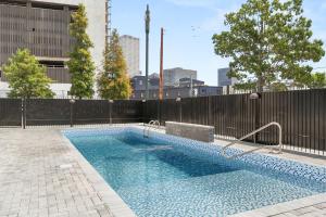 a swimming pool in front of a fence at VCAY Hotel 5BR 5BA Group Suite Near Superdome in New Orleans