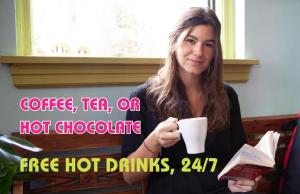 a woman holding a cup of coffee and a book at Ocean Island Inn in Victoria