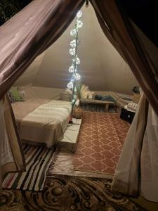 a bedroom with a bed in a tent at Lahemaa Nature Glamping - Kuma in Vihasoo