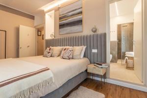 a bedroom with a large bed and a walk in shower at valter rooms 3 in Castel del Piano