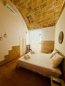 a bedroom with a large bed with a brick ceiling at B&B NONNA TINA in Gemini