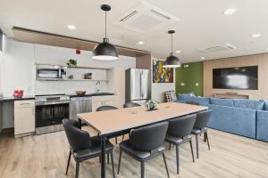 a kitchen and living room with a table and chairs at VCAY Hotel 5BR 5BA Group Suite Near Superdome in New Orleans