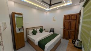 a bedroom with a bed and a wooden door at Palazhi Inn in Trivandrum