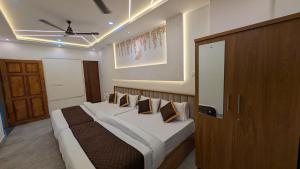a bedroom with a large bed with pillows on it at Palazhi Inn in Trivandrum