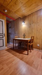 a dining room with a table and two chairs at le relais de l'abelan in Blesle +15 photos
