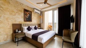 a hotel room with a bed and a window at The Marina Palace Calicut Premium Beach Hotel in Kozhikode