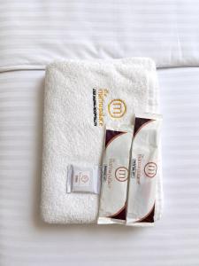 a white towel and a tube of toothpaste on a bed at The Marina Palace Calicut Premium Beach Hotel in Kozhikode +51 photos