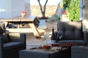 a table with two chairs and a table with wine glasses at Bed & Breakfast Oasi San Giovanni in Altamura