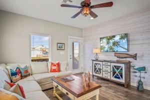 a living room with a couch and a ceiling fan at Mills Fishing Cabin in Port Aransas
