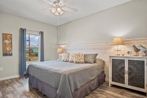 a bedroom with a bed and a ceiling fan at Mills Fishing Cabin in Port Aransas