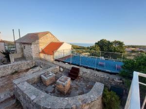 an aerial view of a building with a pool at Holiday Home Tomislav in Komiža