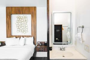 a hotel room with a bed and a sink at Urban Boutique Hotel- Little Italy, Downtown San Diego in San Diego +48 photos