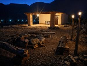 a building with a picnic table in front of it at night at Cabañas Puesta del Sol in Purmamarca