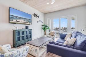 a living room with a blue couch and a table at Port A Del Rey in Port Aransas