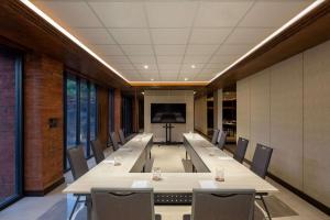 a conference room with a long table and chairs at Garrya Bianti Yogyakarta in Yogyakarta +145 photos