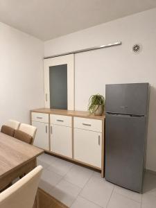 a kitchen with a refrigerator and a table at Peja Riverside Hostel in Peje +9 photos