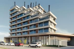 a building with cars parked in front of it at Loft 406 Inn - Parque Una + garagem in Pelotas