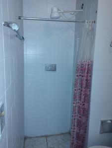a bathroom with a shower with a shower curtain at Apartamento para duas pessoas com cama de casal in Teresópolis