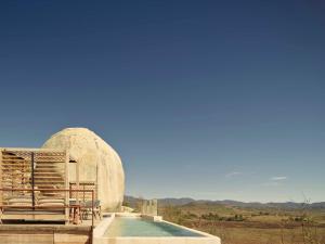 a dome observatory with a pool in the foreground at Banyan Tree Veya, Valle de Guadalupe in Valle de Guadalupe