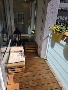 a porch with two benches on a house at Brenz City Stay in Heidenheim an der Brenz