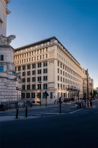 a large stone building on a city street at Hyatt Regency London Blackfriars in London