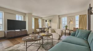 a living room with a couch and a tv at Hyatt Regency London Blackfriars in London