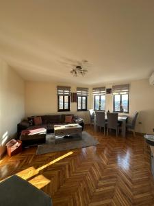 a living room with a couch and a table at Apartment Zdravets, in the heart of the old city in Veliko Tŭrnovo +29 photos