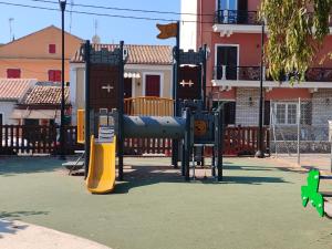 a playground with a slide in front of a building at CASA THEOTOKI in Anemómylos
