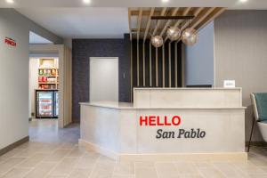 a hotel lobby with a hello san polo counter at TownePlace Suites by Marriott San Pablo in San Pablo