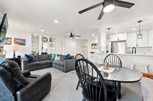 a living room with a couch and a table at G6 - Answered Prayers Cottage in Oceanside