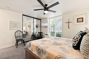 a bedroom with a bed and a ceiling fan at G6 - Answered Prayers Cottage in Oceanside +68 photos