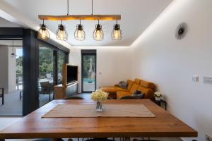a living room with a table and a couch at Andrea Deluxe Apartment with Pool in Mali Lošinj