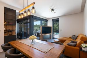 a living room with a table and a couch at Andrea Deluxe Apartment with Pool in Mali Lošinj