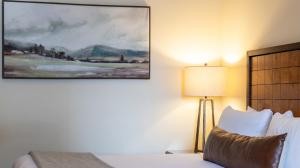 a bedroom with a bed and a painting on the wall at 147 Studio Spruce Peak Lodge at Stowe Mt Resort Sleeps 4 in Stowe +11 photos