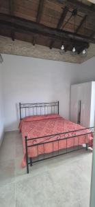 a bedroom with a bed with a red comforter at Dimora del Cammino di Cancellara in Foligno +3 photos