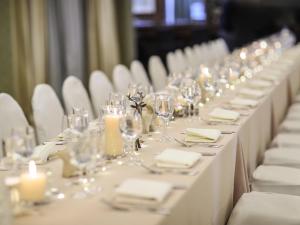 a row of tables with white plates and glasses and candles at Sofitel Beirut Le Gabriel in Beirut +83 photos